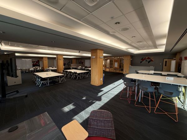 Interior of Prior 550 conference room, featuring variety of group tables and chairs.