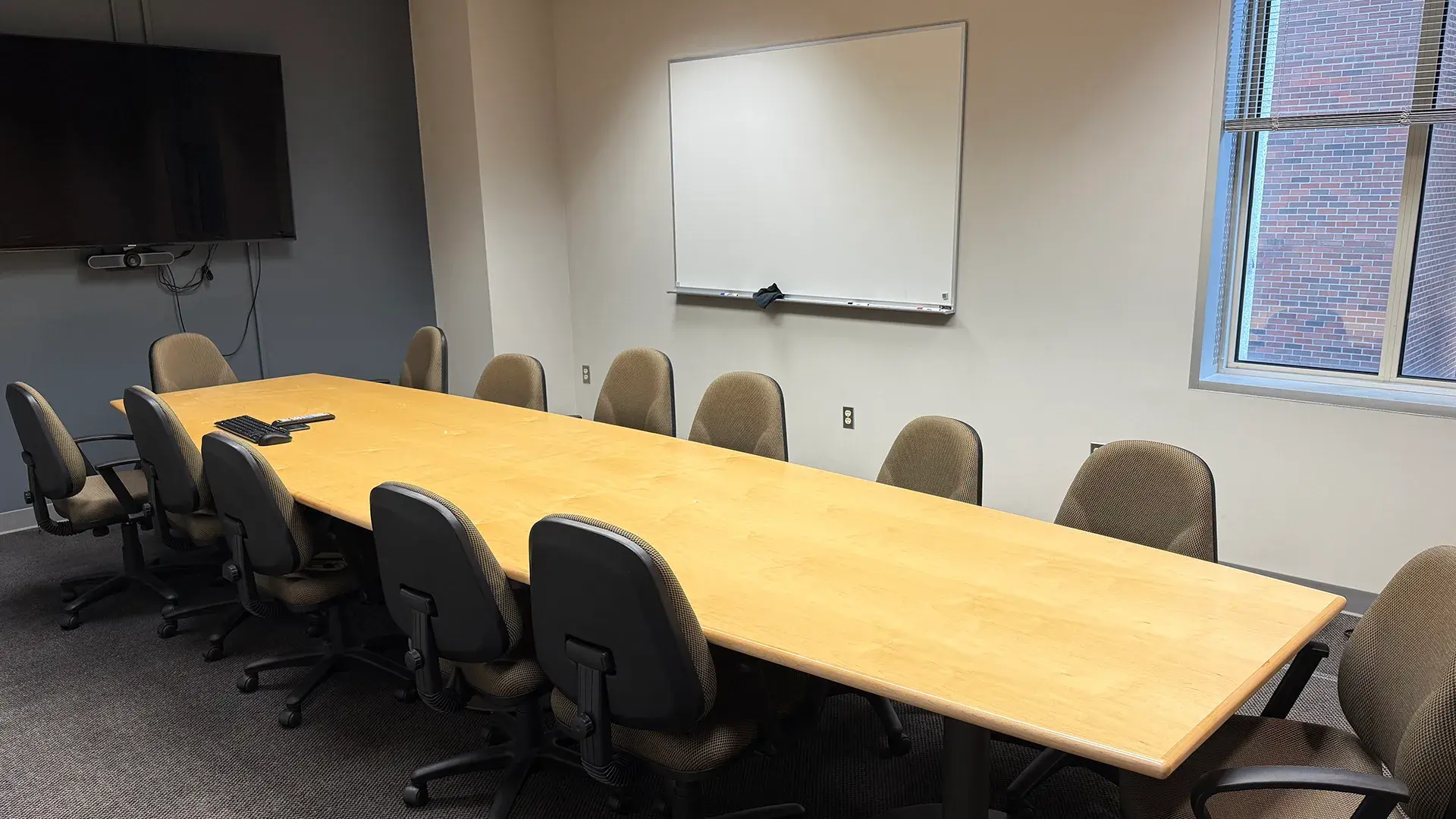 Interior of 214 interview room showing conference table and chais. 