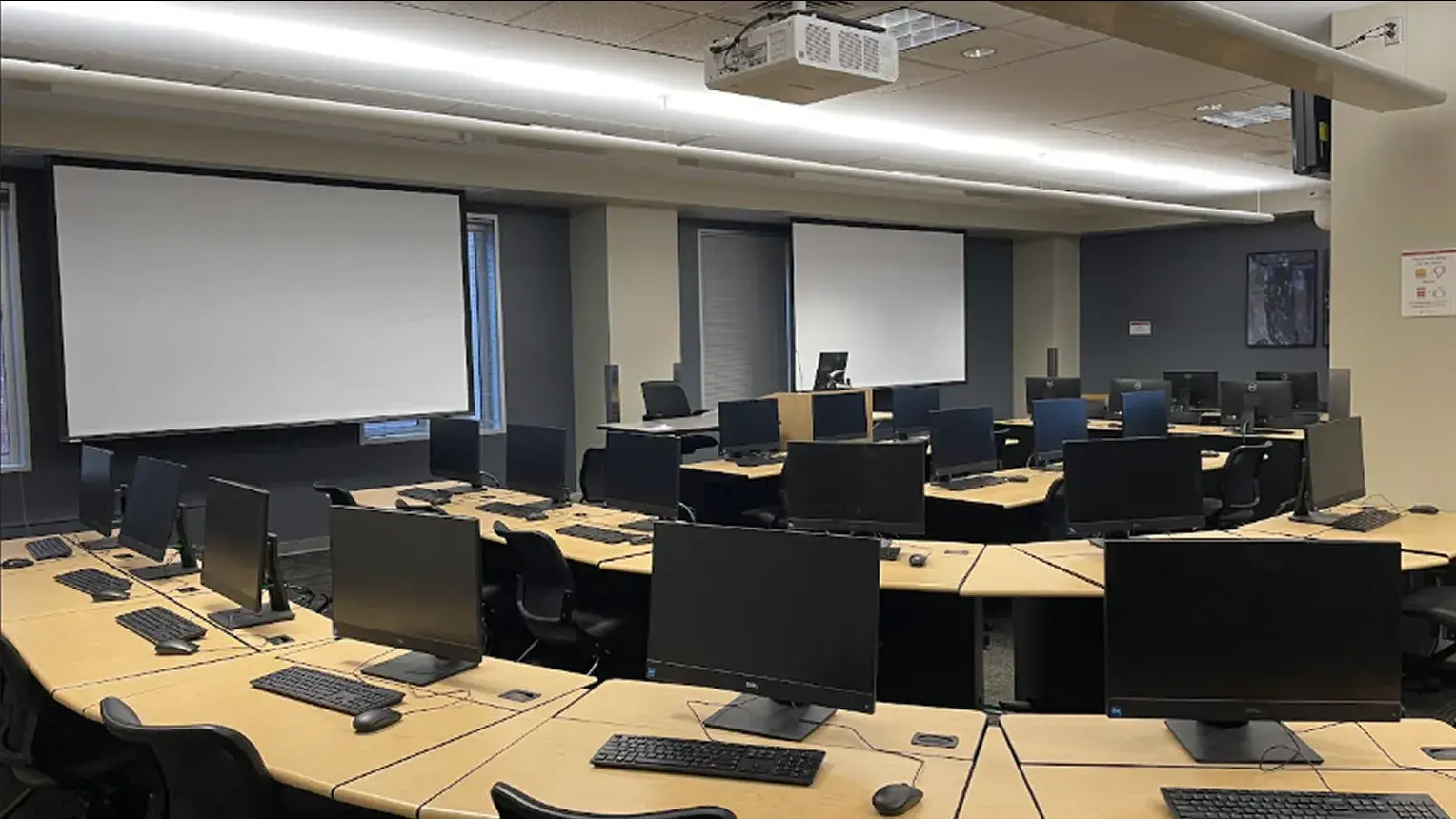 Interior showing desks and projector screens of 460B Computer Lab.