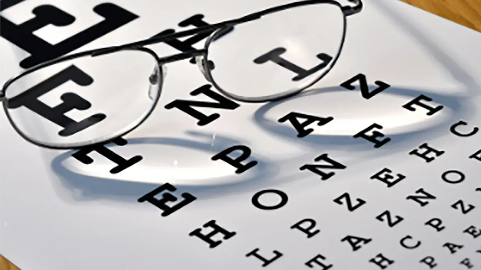 a pair of glasses sitting on top of an eye chart to represent the endowment fund