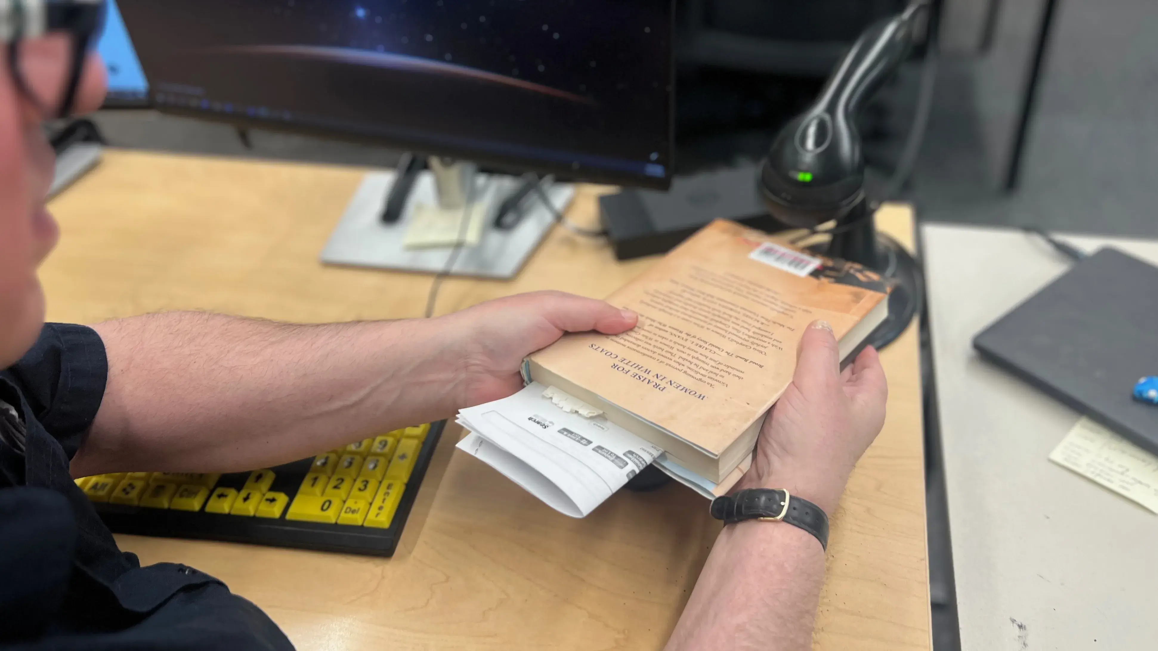 A librarian scanning a book's barcode.