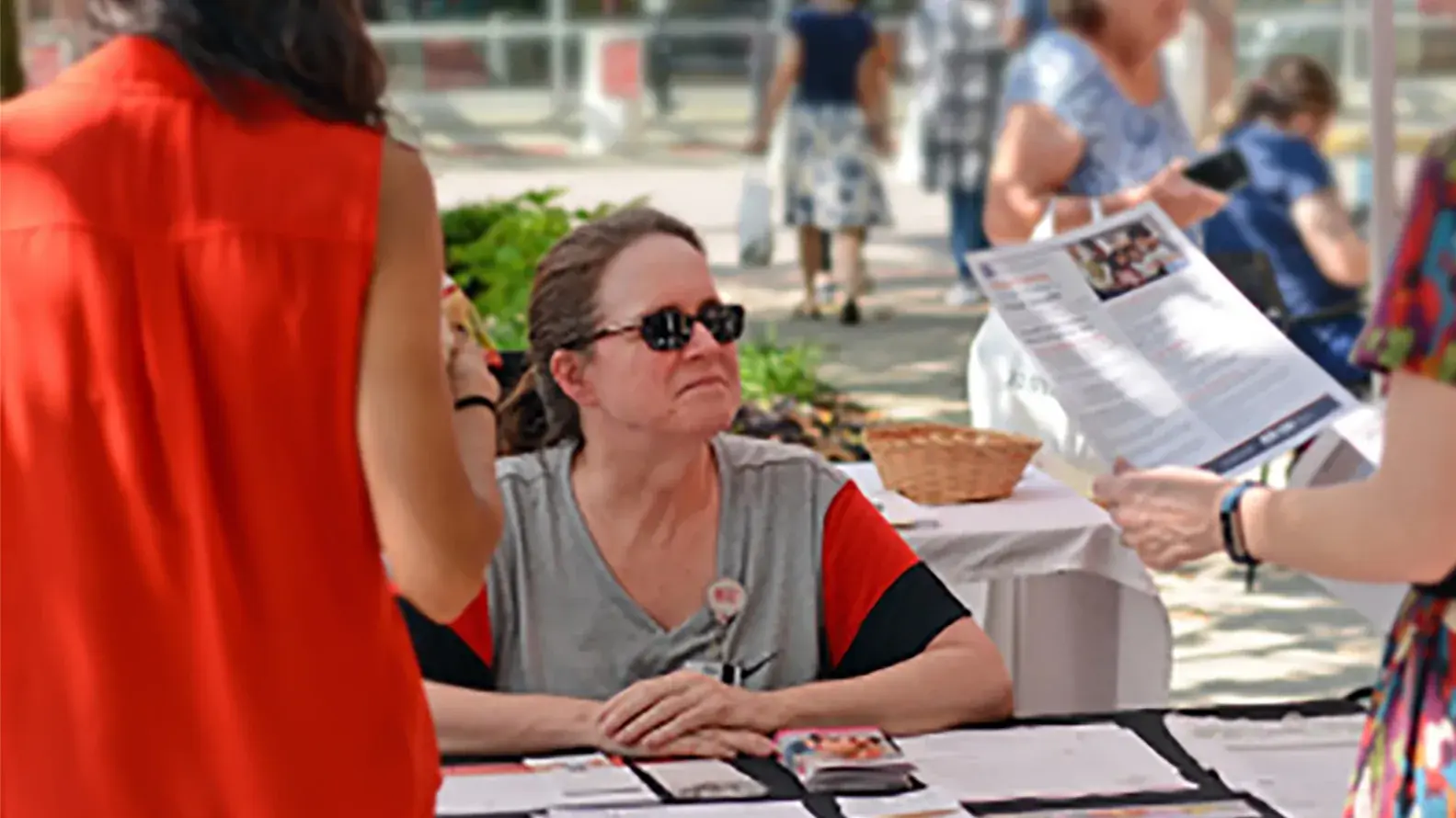 woman handing out pamphlets at a donation drive