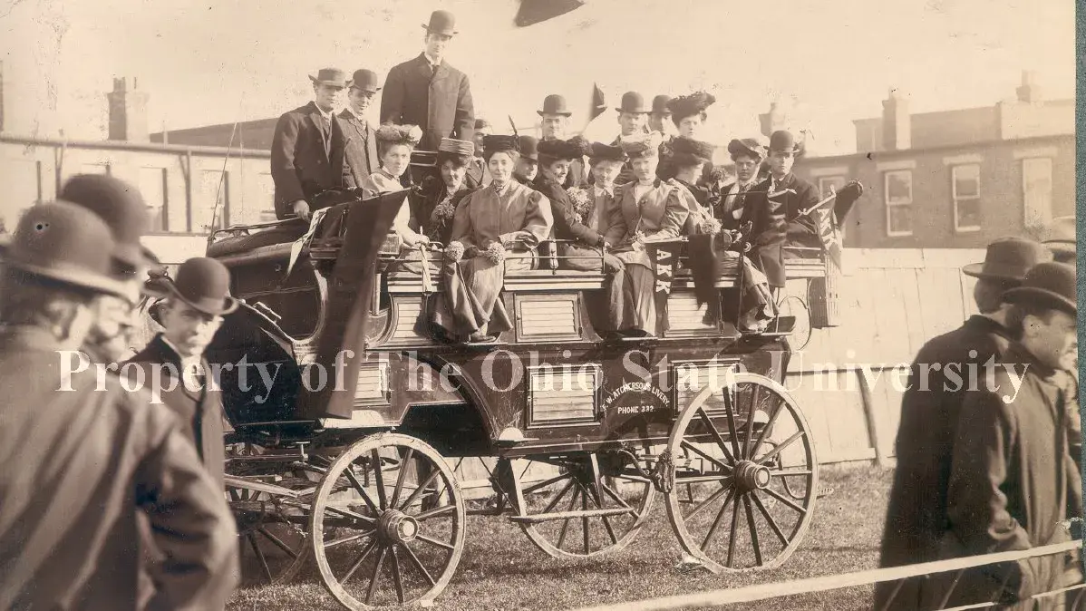 stagecoach with group of nicely dressed men and women from the early 1900s