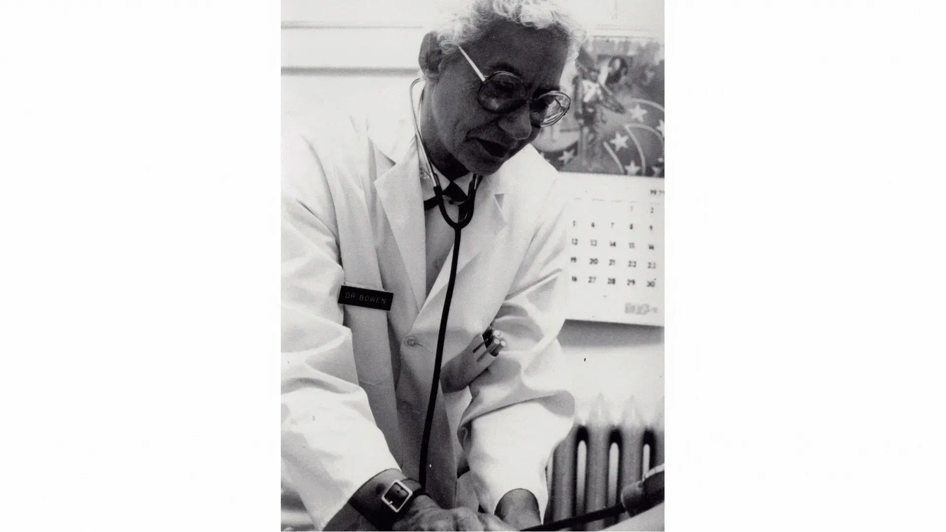 Clotilde Bowen, wearing a lab coat and stethoscope, actively working.