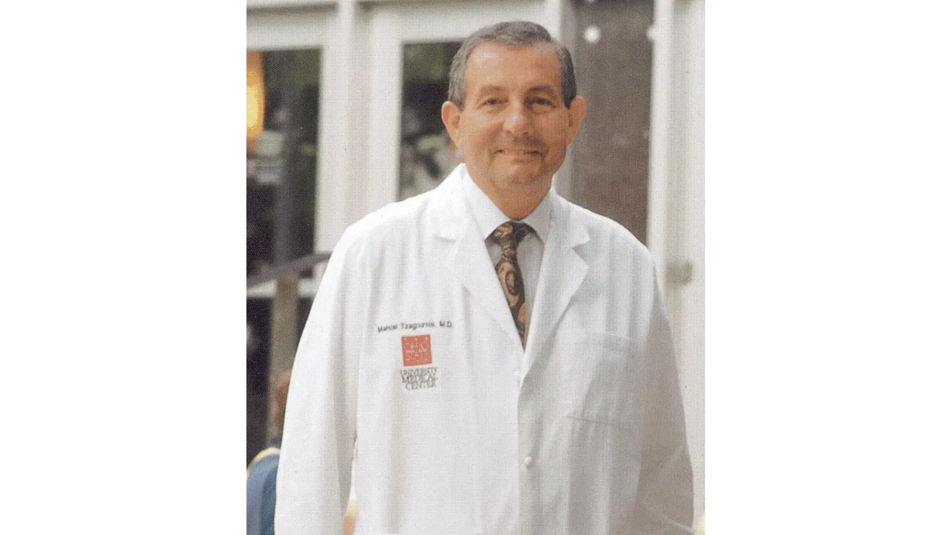 Manuel Tzagournis as a physician, wearing an Ohio State lab coat.