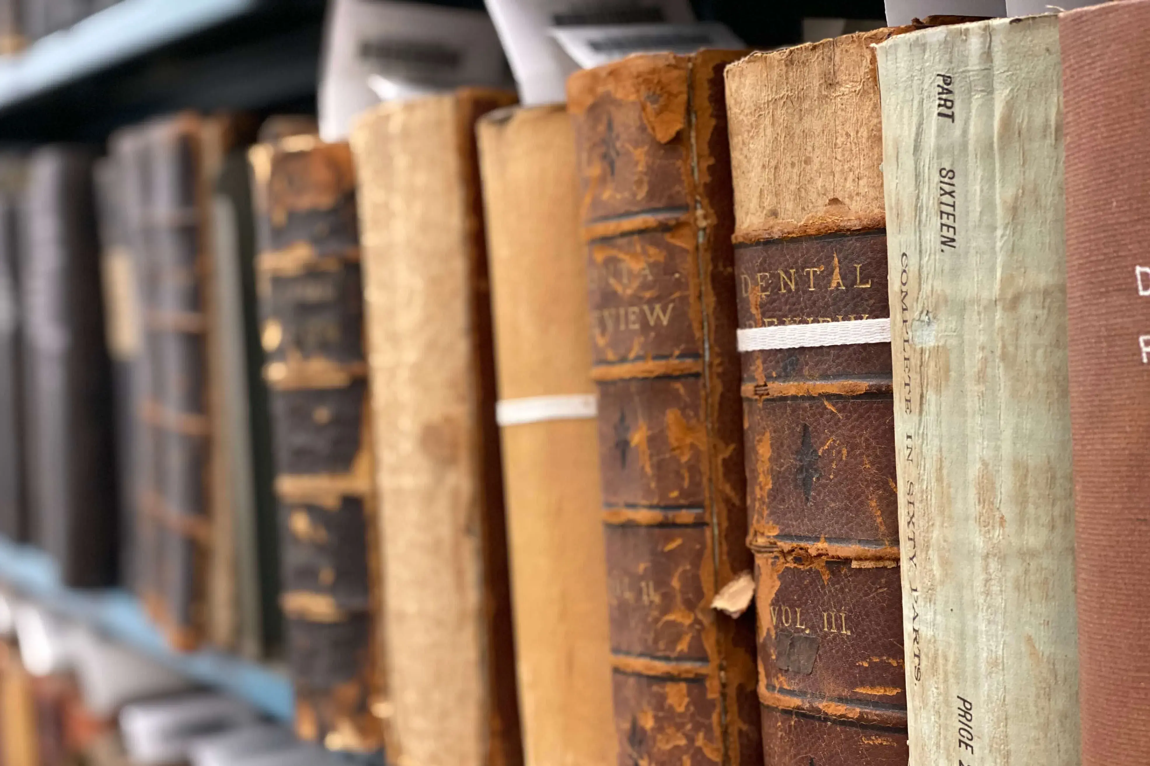 Collection of rare, old books on a shelf. 
